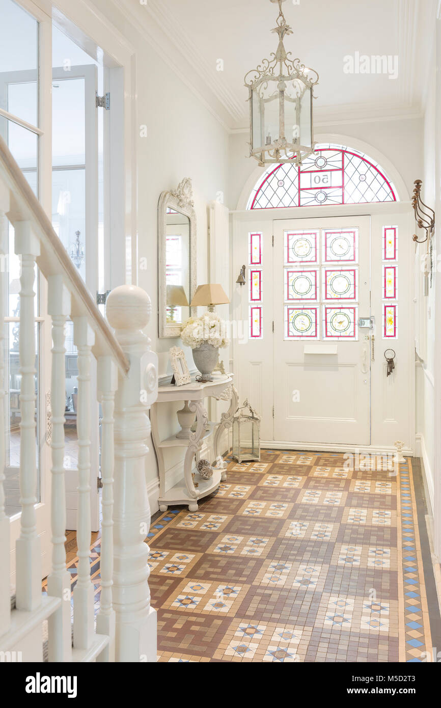 White, luxury home showcase interior foyer with chandelier Stock Photo