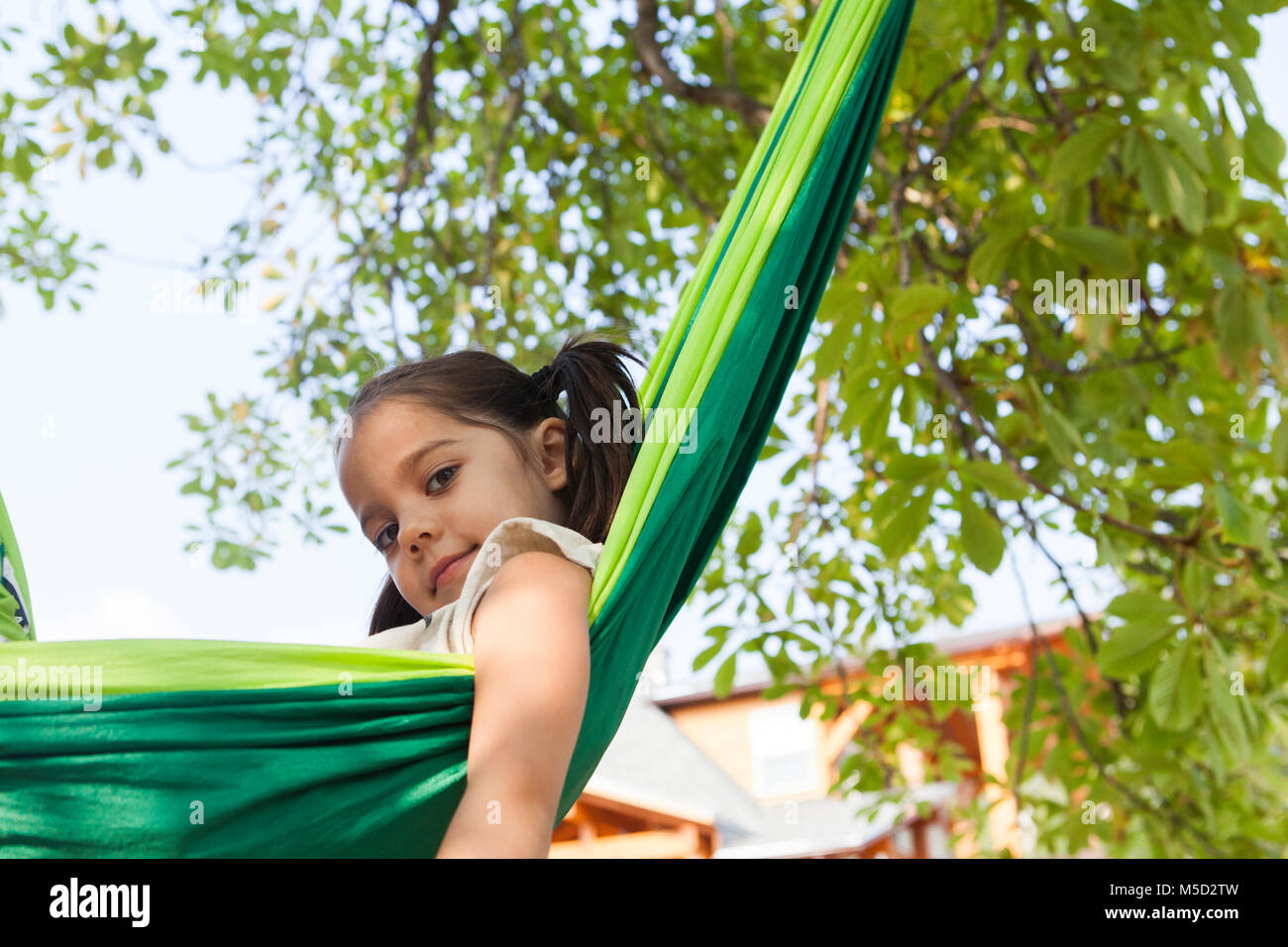 Portrait confident girl in green hammock Stock Photo
