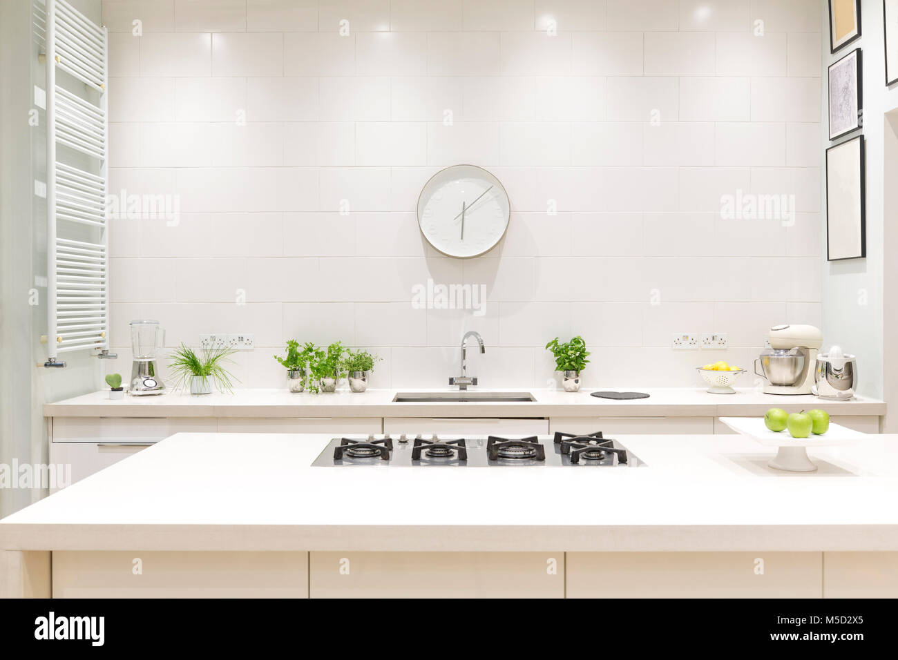 White, modern luxury home showcase interior kitchen with clock Stock Photo