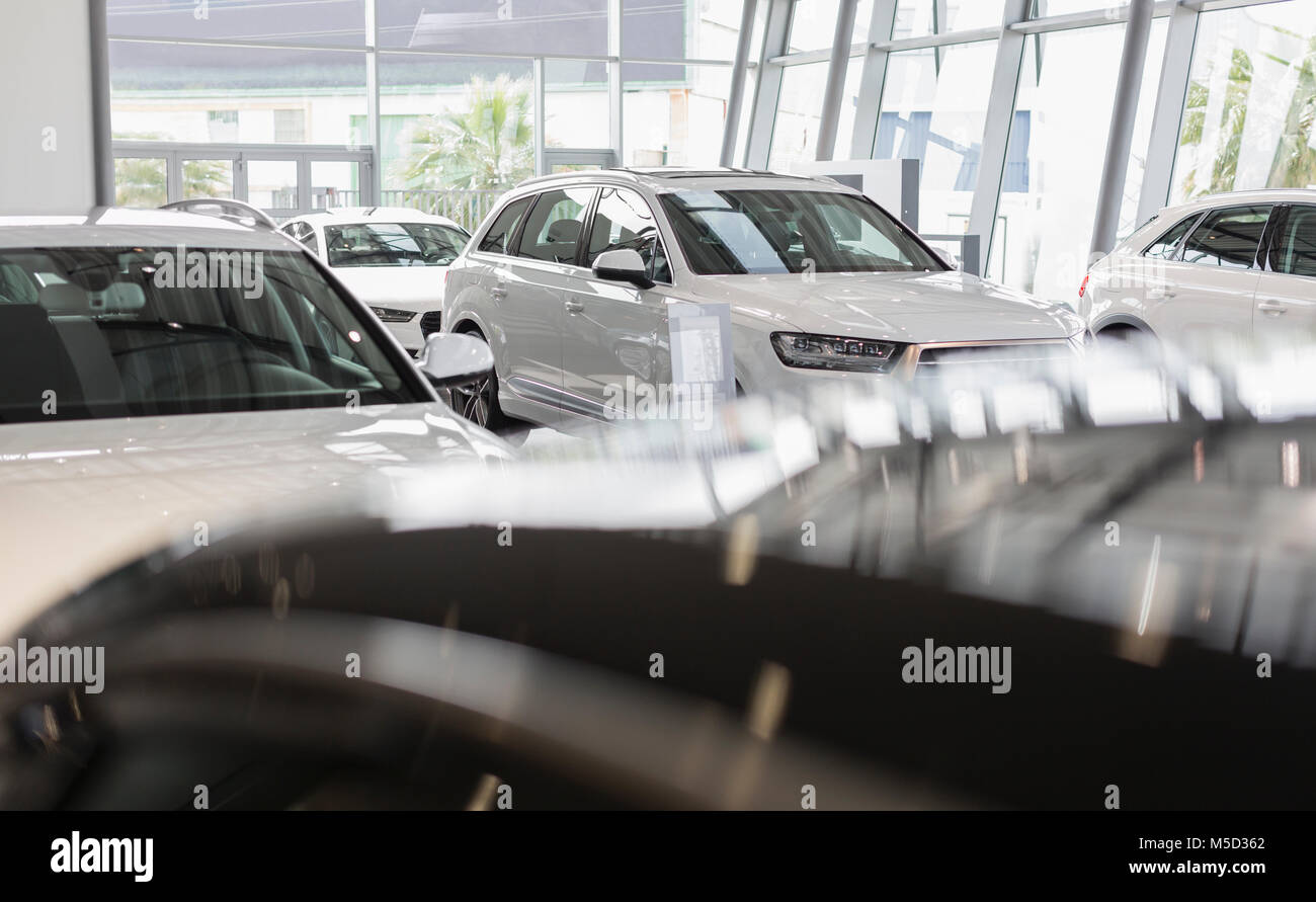 New, white cars in car dealership showroom Stock Photo