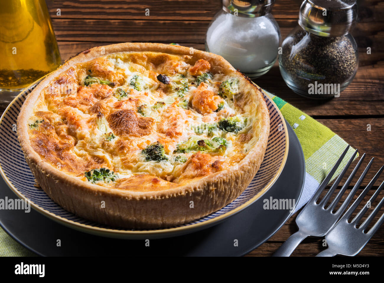 Classic salmon and broccoli quiche made from shortcrust pastry with broccoli florets and smoked salmon in a creamy free range egg custard Stock Photo