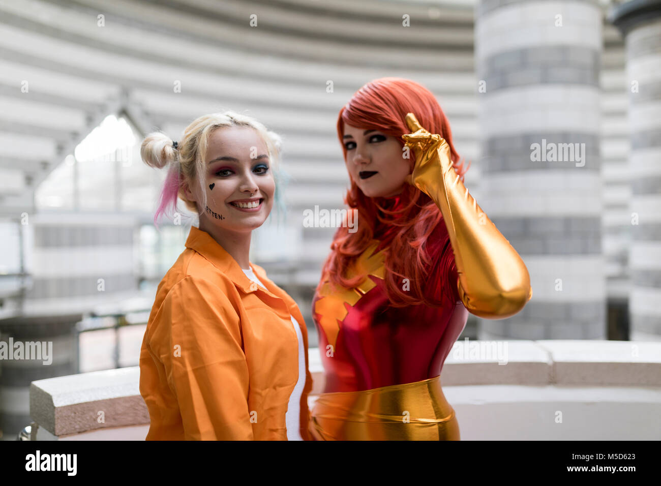 Doncaster Comic Con 11th Feruary 2018 at The Doncaster Dome. Two young women cosplay as Harley Quinn from Suicidé Squad and Marvel’s Jean Grey Phoenix Stock Photo