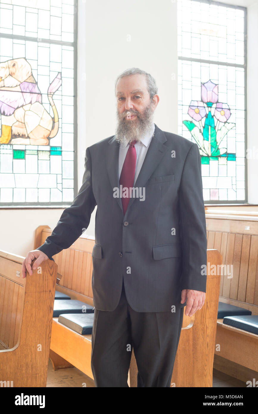 Staring Rabbi a rabbi stands in a synagogue for a portrait Stock Photo - Alamy