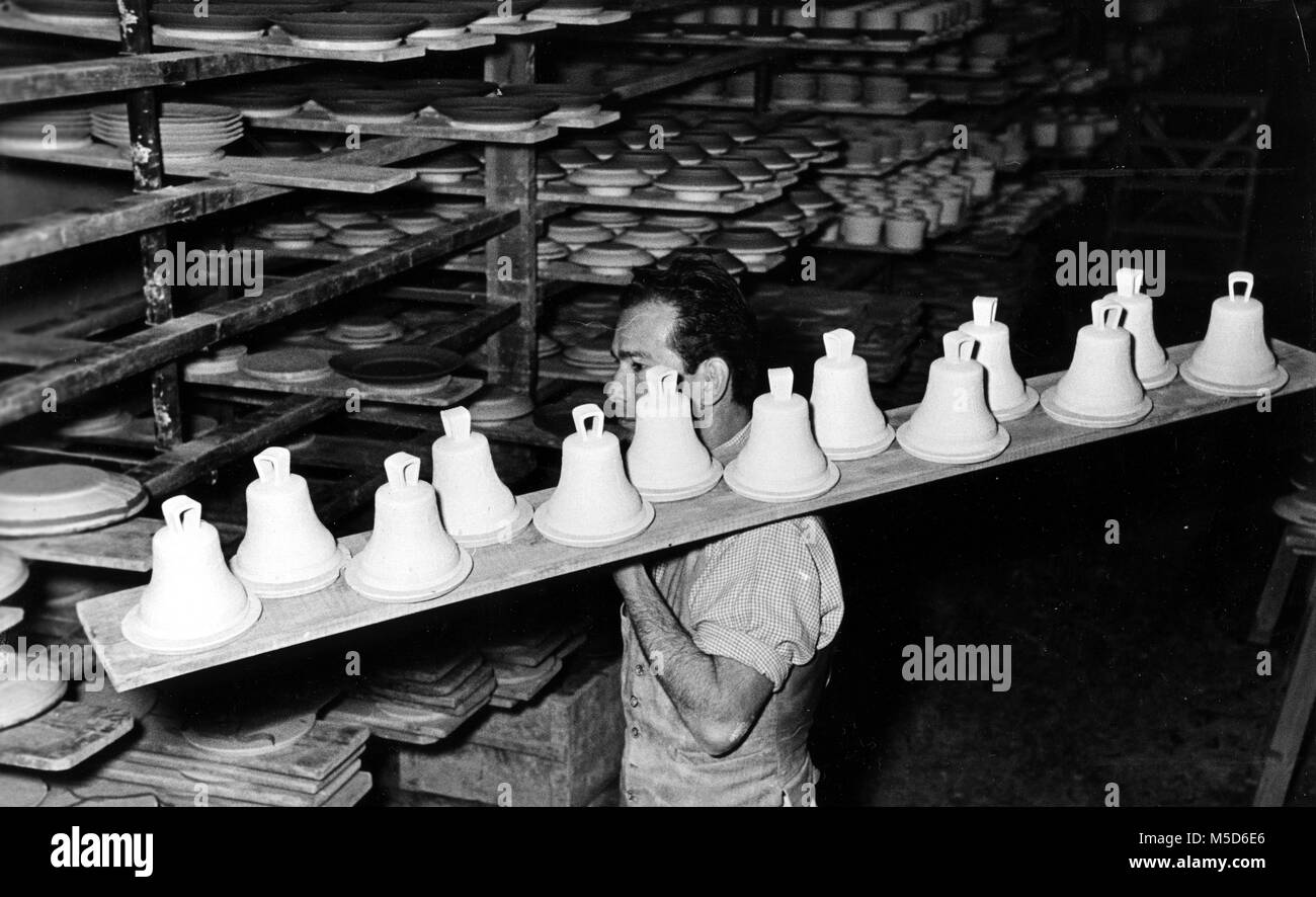 Man transports ceramic bells for firing, 1960s, Berlin, Germany Stock Photo