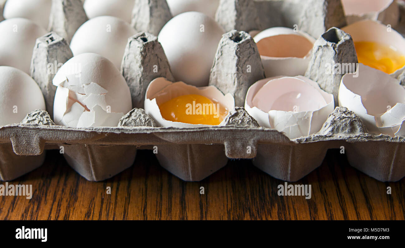 cracked white eggs in carton Stock Photo