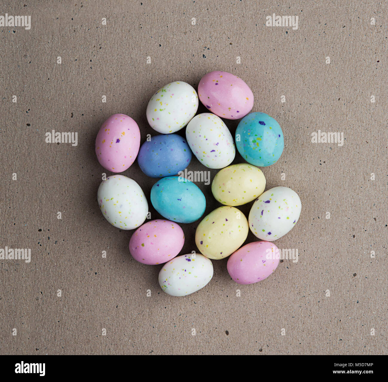 Easter candy eggs over brown background Stock Photo