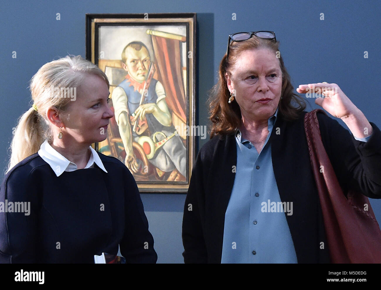 22 February 2018, Germany, Potsdam: Mayen Beckmann (R), grandchild of the painter Max Beckmann, stands next to museum director Ortrud Westheider in front of a self-portrait of her grandfather at the Museum Barberini. From Saturday onwards (24 February 2018) the museum will show a retrospective of Max Beckmann's work with the title 'Welttheater' (lit. world theatre) with more than hundred loan exhibits from German and international museums and private collections. Photo: Bernd Settnik/dpa-Zentralbild/dpa - ACHTUNG: Nur zur redaktionellen Verwendung im Zusammenhang mit einer Berichterstattung üb Stock Photo