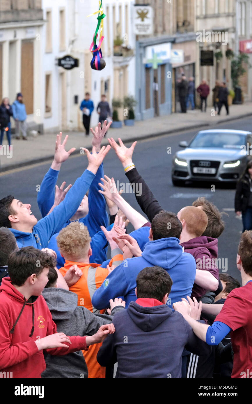 Jedburgh, Mercat Cross, UK. 22nd Feb, 2018. Jed Hand Ba' The annual game of hand ball takes place every year the Thursday after Fastern's E'en. The tradition derives from 1548 when a party of Scots recaptured Ferniehirst Castle, a mile south of Jedburgh and used an Englishman's head in a celebratory game after the battle. the Schule Ba, the first to be thrown up at 12 noon, for the boys games ( Credit: Rob Gray/Alamy Live News Stock Photo