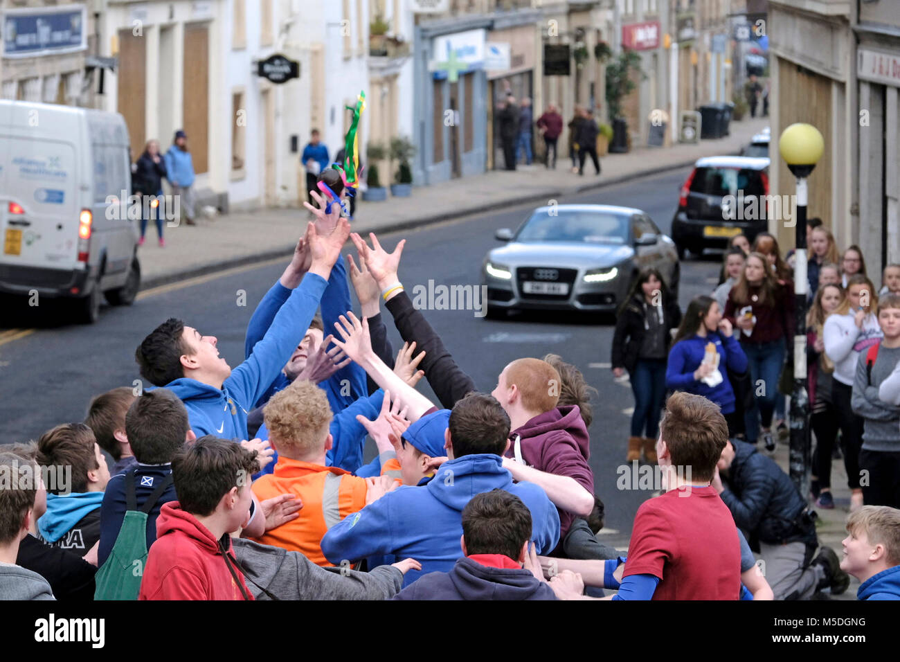 Jedburgh, Mercat Cross, UK. 22nd Feb, 2018. Jed Hand Ba' The annual game of hand ball takes place every year the Thursday after Fastern's E'en. The tradition derives from 1548 when a party of Scots recaptured Ferniehirst Castle, a mile south of Jedburgh and used an Englishman's head in a celebratory game after the battle. the Schule Ba, the first to be thrown up at 12 noon, for the boys games ( Credit: Rob Gray/Alamy Live News Stock Photo