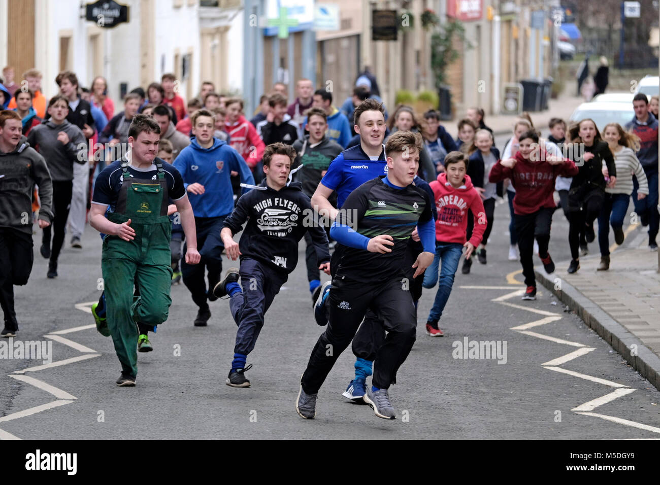 Jedburgh, Mercat Cross, UK. 22nd Feb, 2018. Jed Hand Ba' The annual game of hand ba' takes place every year the Thursday after Fastern's E'en. The tradition derives from 1548 when a party of Scots recaptured Ferniehirst Castle, a mile south of Jedburgh and used an Englishman's head in a celebratory game after the battle. younger faster boys can make a sprint with the ba' ( Credit: Rob Gray/Alamy Live News Stock Photo