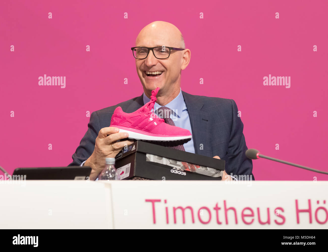 Bonn, Germany. 22nd Feb, 2018. Deutsche Telekom annual news conference: CEO  Tim Hoettges displays a magenta sports shoe. Credit: Juergen Schwarz/Alamy  Live News Stock Photo - Alamy