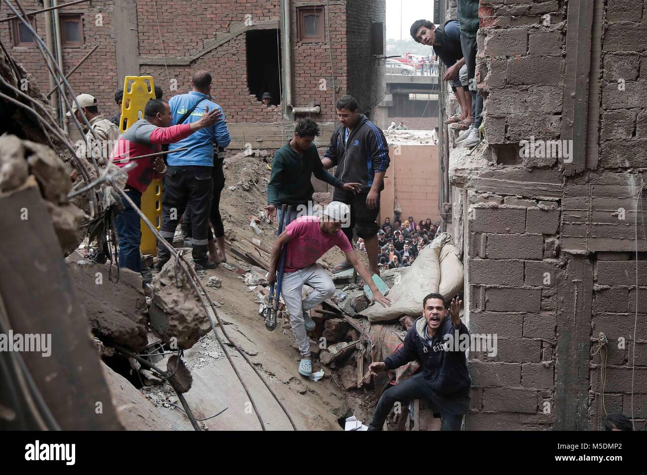 Cairo. 22nd Feb, 2018. Rescuers search for survivors at a building ...