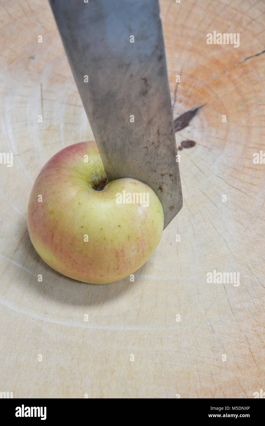 knife cut apple on wooden chop block Stock Photo Alamy