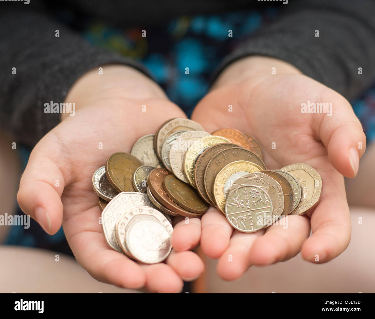 A child holding some coins (child savings concept) Stock Photo