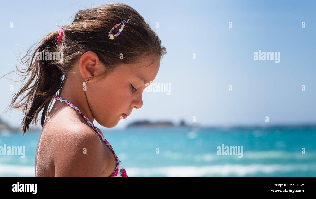 Pensive little girl on the shore of the sea Stock Photo Alamy