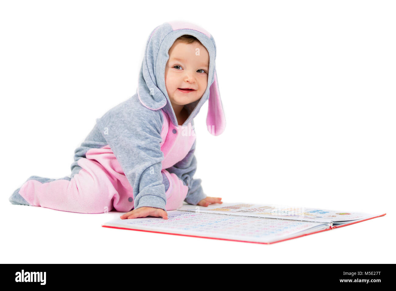 Portrait of a smiling child with a book on a white background Stock ...