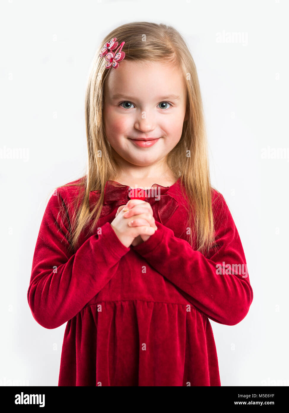Portrait of a beautiful little smiling girl. Child on a light background Stock Photo