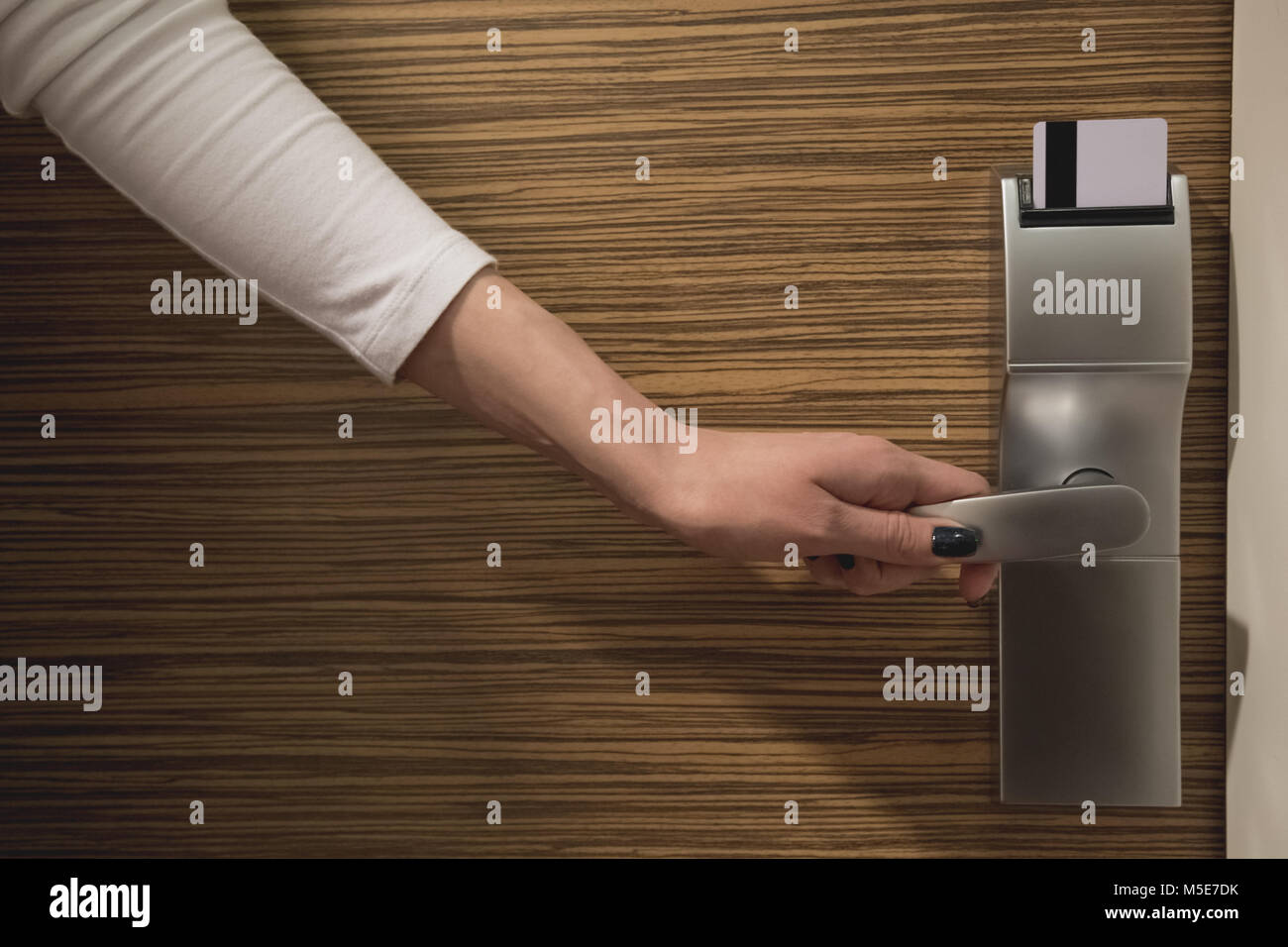 Close up of female hand opening keycard electronic lock Stock Photo