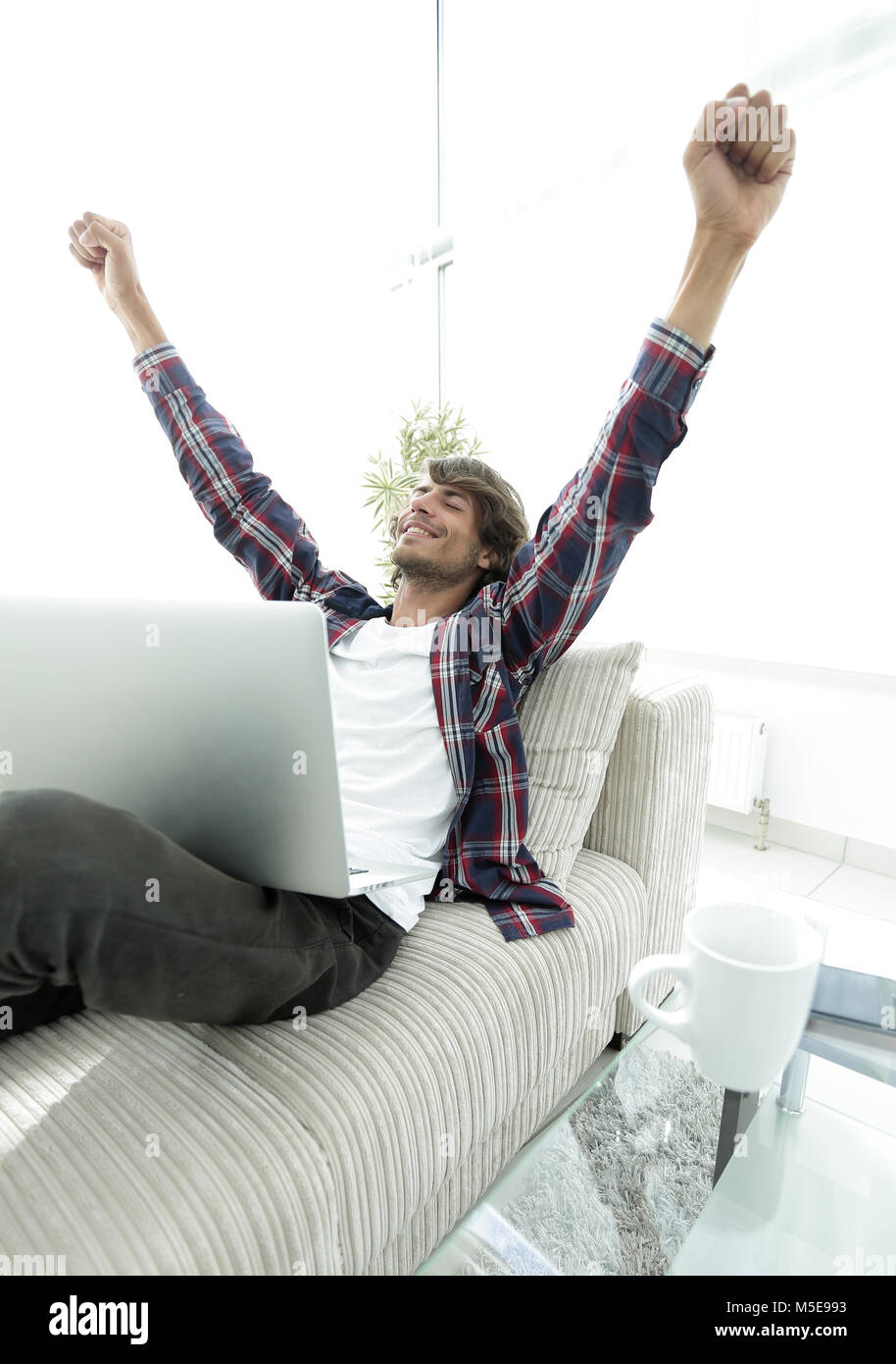 very happy young man working with laptop at home Stock Photo - Alamy