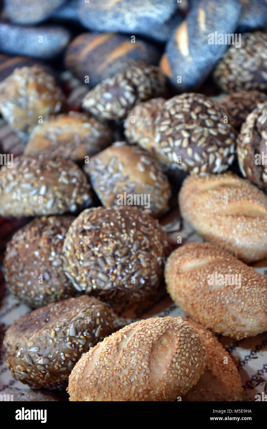 A selection of rolls and baps bagels ready for sale on an artisan bakery stall at london borough market. Artisan bakers baking bread selling. Stock Photo