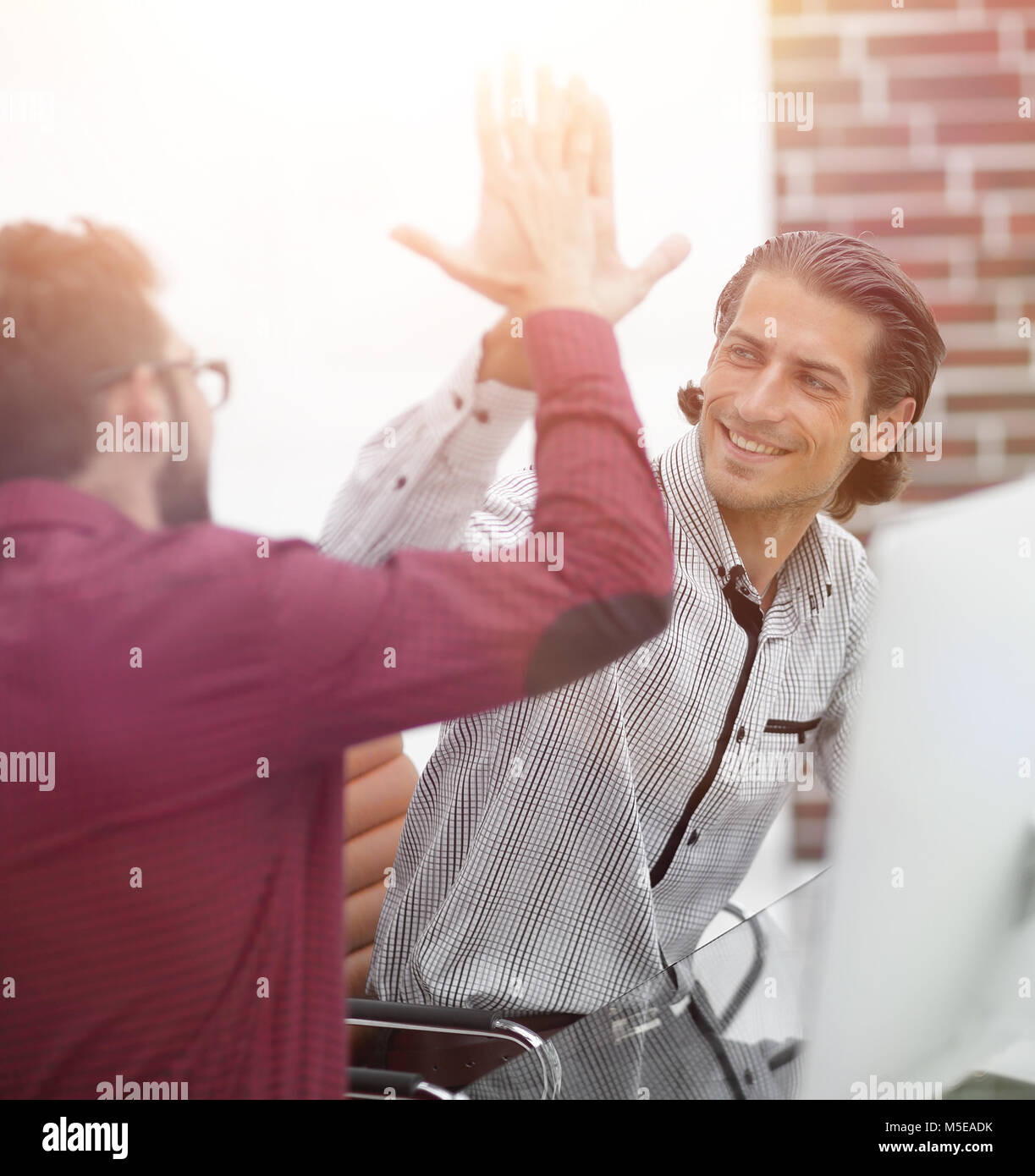 happy employees giving each other high five Stock Photo - Alamy