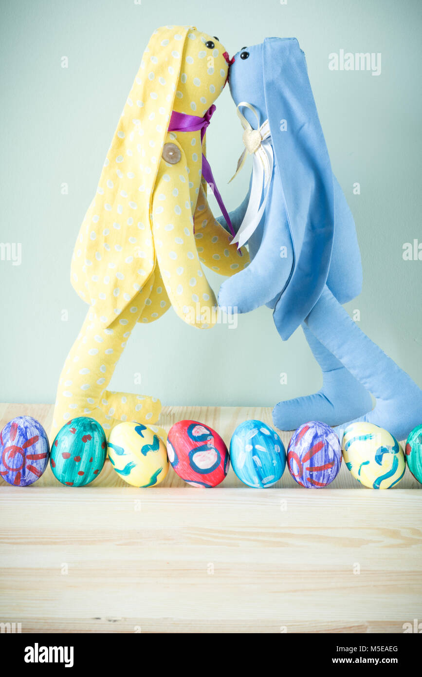 Two easter bunnies on a wooden table Stock Photo