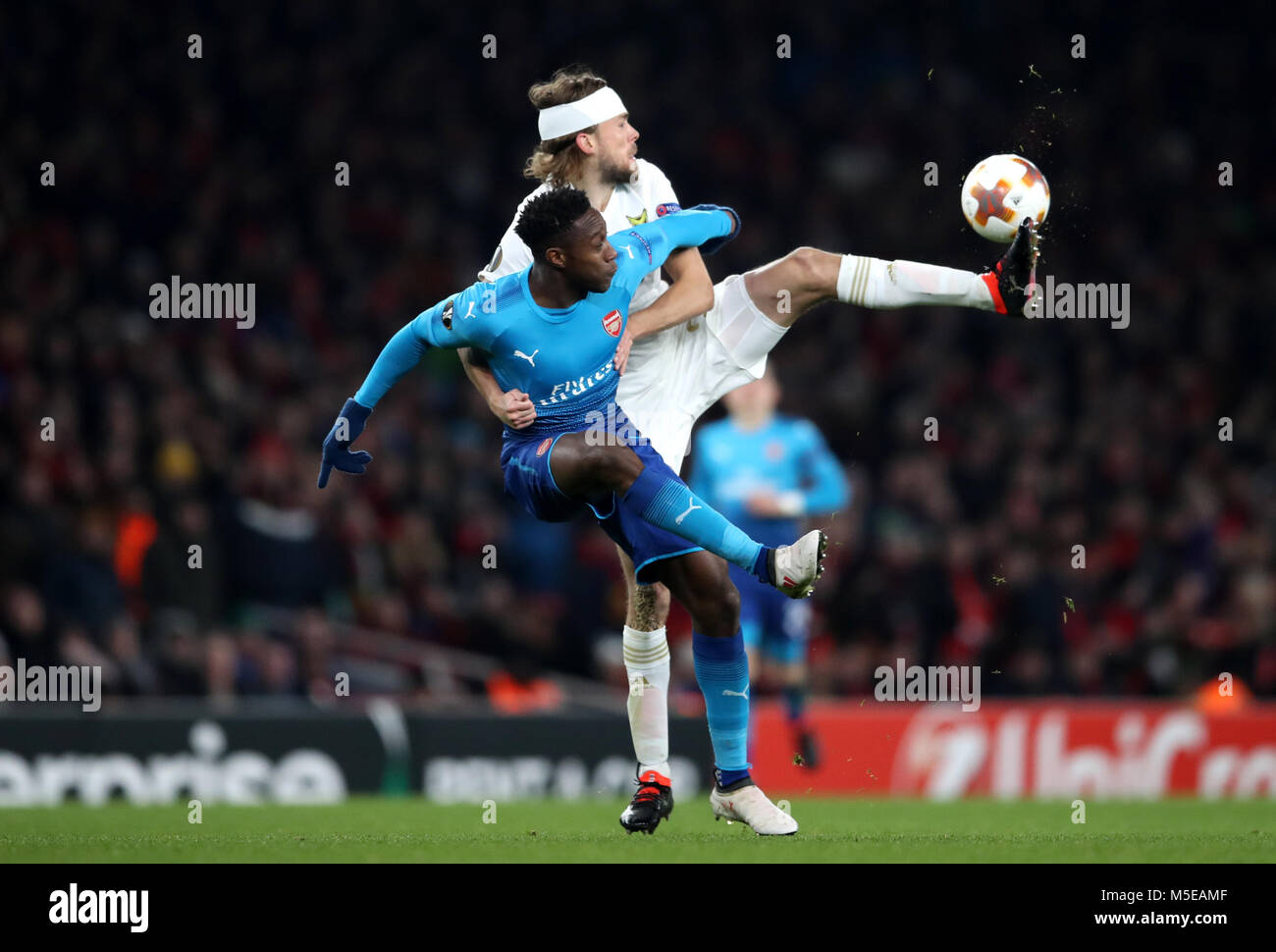 Ostersunds FK's Curtis Edwards and Arsenal's Danny Welbeck gestures on the touchline during the UEFA Europa League round of 32, second leg match at the Emirates Stadium, London. Stock Photo