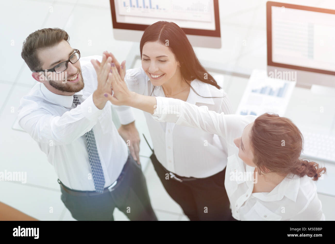successful business team giving each other a high five Stock Photo - Alamy