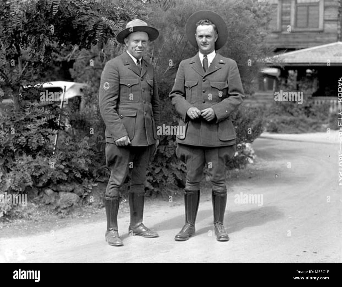 Grand Canyon Rangers Williamson and Cox   2  RANGERS, R.R. WILLIAMSON & CARL COX, STAND IN UNIFORM IN FRONT OF THE EL TOVAR HOTEL. JUNE 1931. Stock Photo