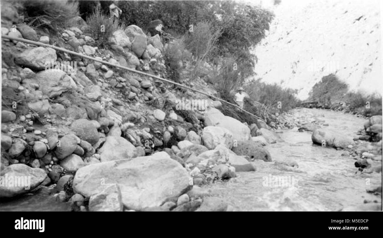 Grand Canyon Historic- Bright Angel Creek Flood Damage   FLOOD DAMAGE OF AUGUST 4-5, 1948.  SHOWING DAMAGE TO NATIONAL PARK SERVICE WATER SYSTEM WHICH SERVES CAMPGROUND AND ROCK HOUSE TRAIL STATION, INNER CANYON, GRCA.   ON EAST SIDE OF BRIGHT ANGEL CREEK NEAR PHANTOM RANCH ORCHARD.   CIRCA 1948.   . Stock Photo