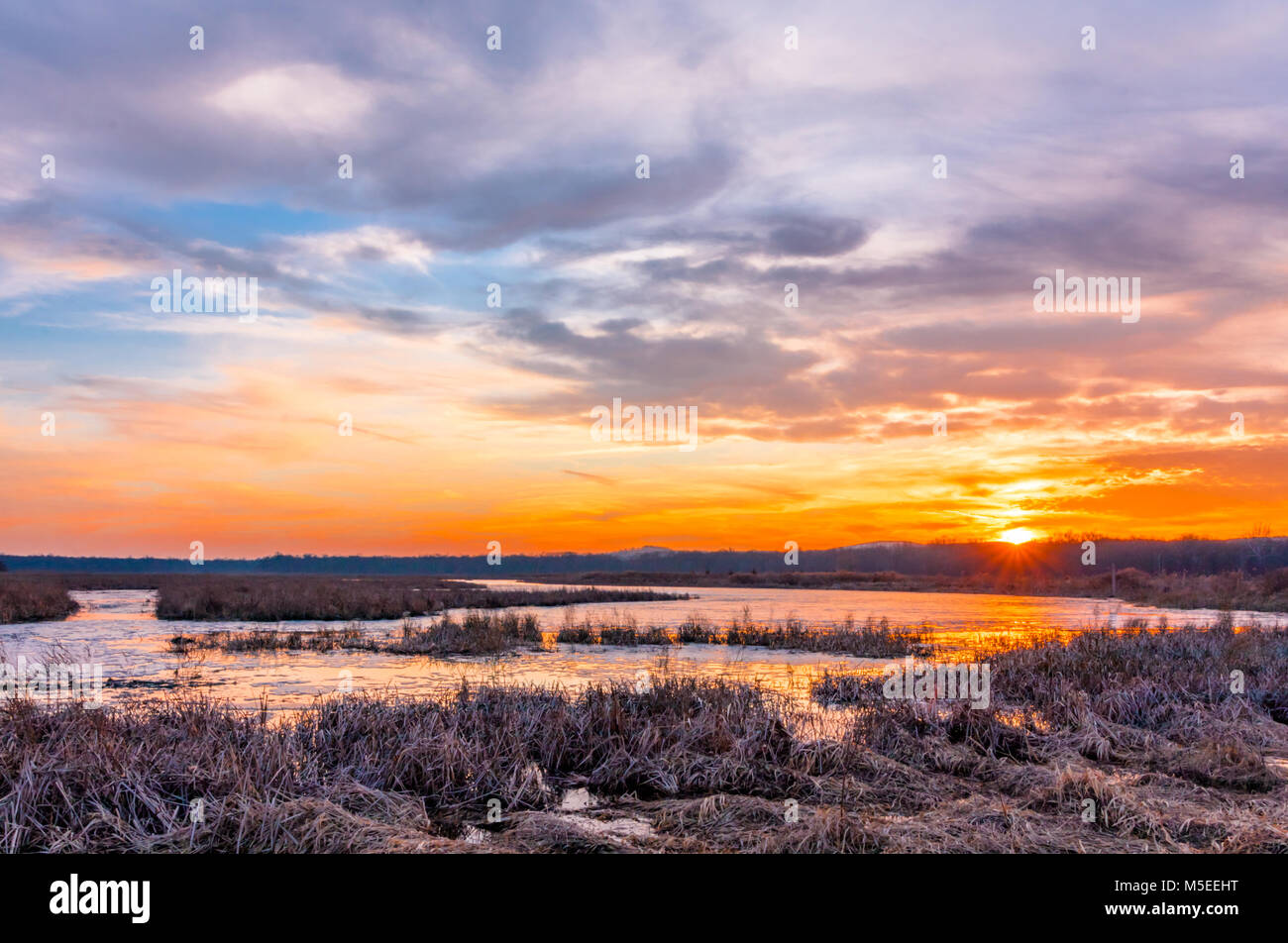 Sunset at Liberty Loop, part of the Wallkill River NWR, NJ, in late winter as the ice melts off the marshlands Stock Photo