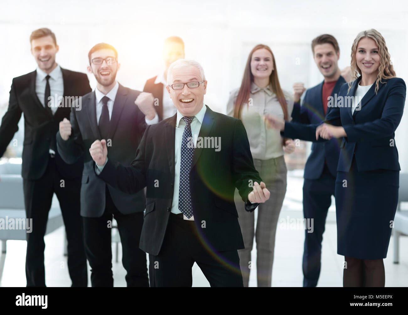 happy senior businessman and triumphant business team Stock Photo - Alamy