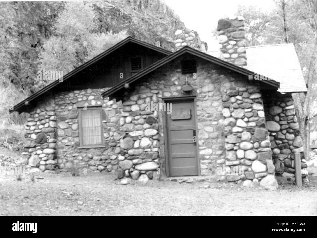 Grand Canyon Historic- Phantom Ranch Shower House   PHANTOM RANCH SHOWER HOUSE, SANDSTONE CHUNK CONSTRUCTION, DOUBLE GABLE.  NORTHERN ELEVATION.  MARCH 13, 1985. Stock Photo