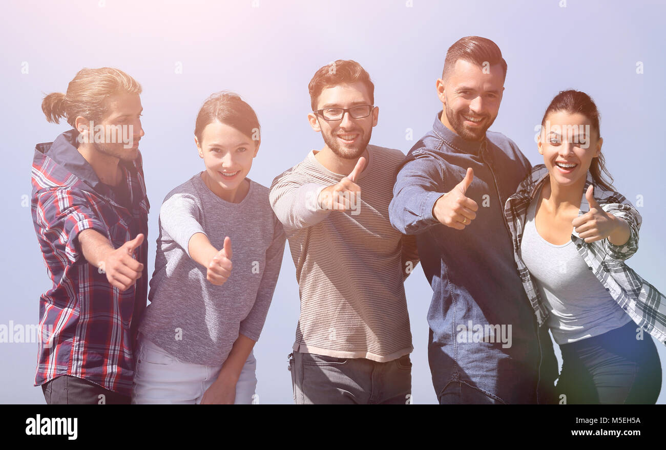 smiling group of young people showing thumb up Stock Photo - Alamy