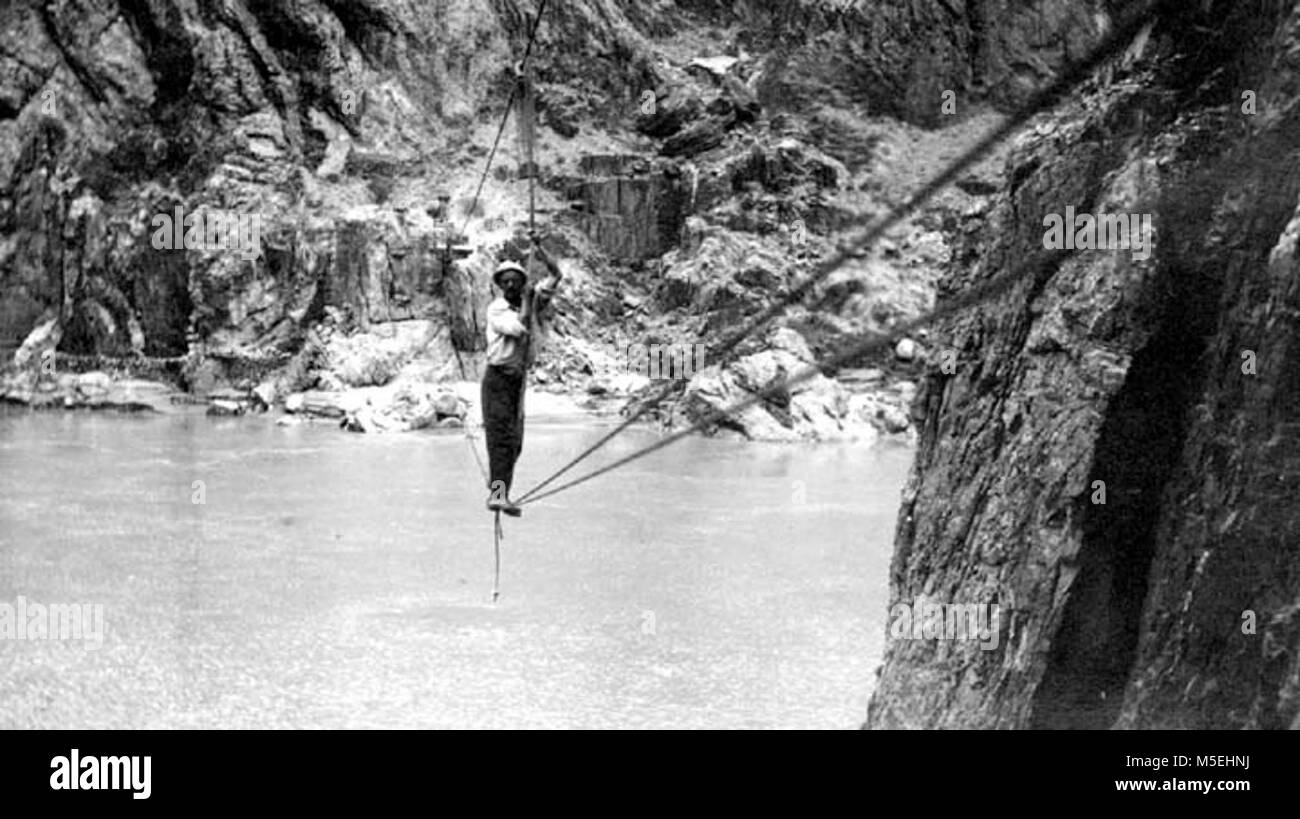 Grand Canyon Historic - Colorado River Cable Crossing c  MR SWEENY WALKING CABLE TRAMWAY ACROSS THE COLORADO RIVER. CIRCA 1909. Stock Photo