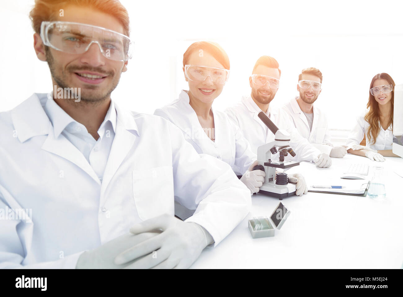 Male scientist and the team in the lab Stock Photo - Alamy