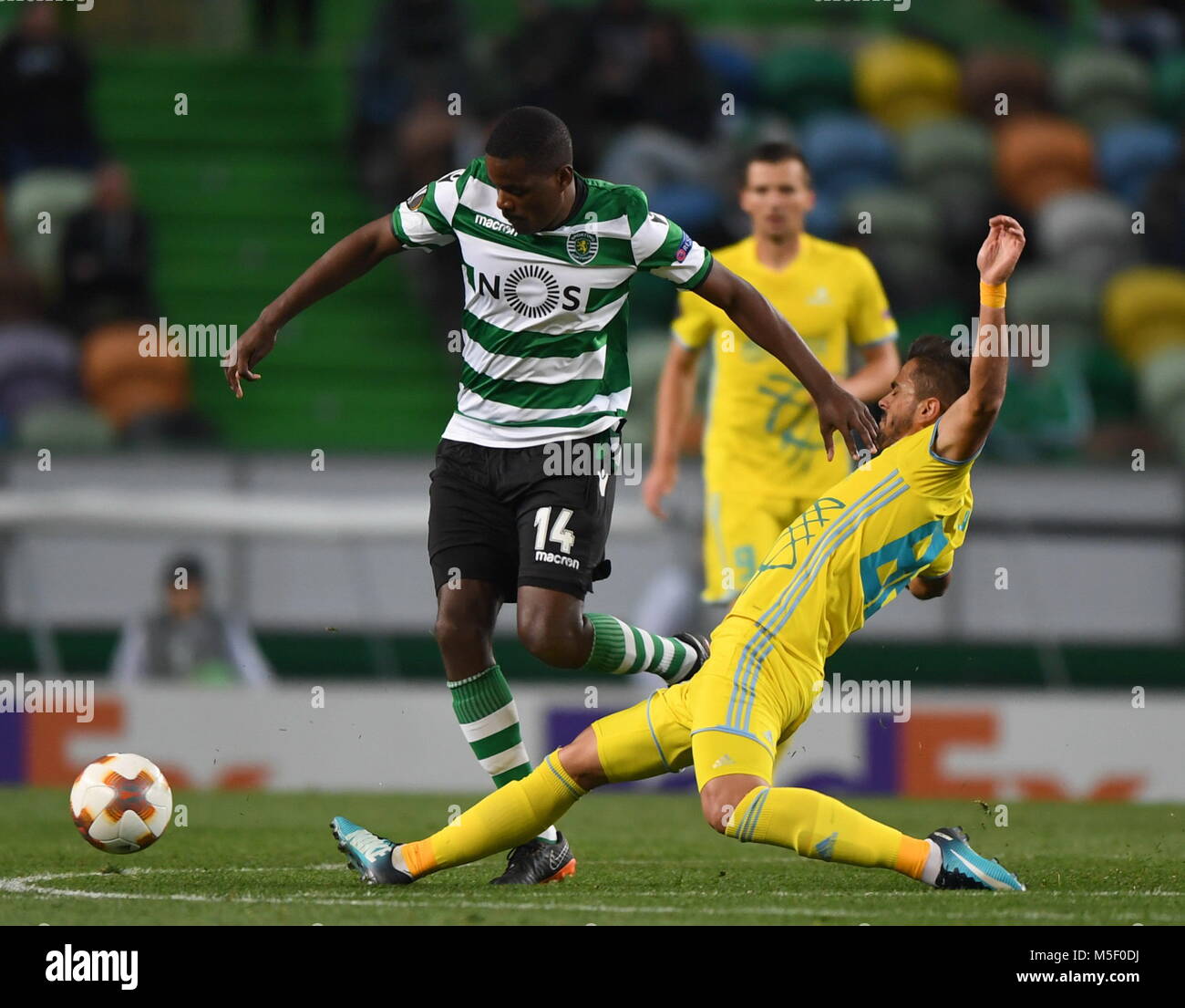 (180223) -- LISBON, Feb. 23, 2018 (Xinhua) -- William Carvalho (L) of Sporting vies for the ball with Marko Stanojevic of Astana during the Europa League soccer match between Sporting CP and FC Astana at the Jose Alvalade stadium in Lisbon, Portugal, on Feb. 22, 2018. The match ended with a 3-3 tie.(Xinhua/Zhang Liyun) Stock Photo