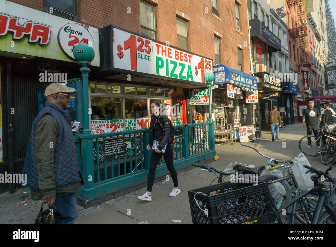 The generically named 'The Best Pizza', a dollar pizzeria, and other local businesses on West 23rd Street in the Chelsea neighborhood of New York on Tuesday, February 20, 2018.  (Â© Richard B. Levine) Stock Photo