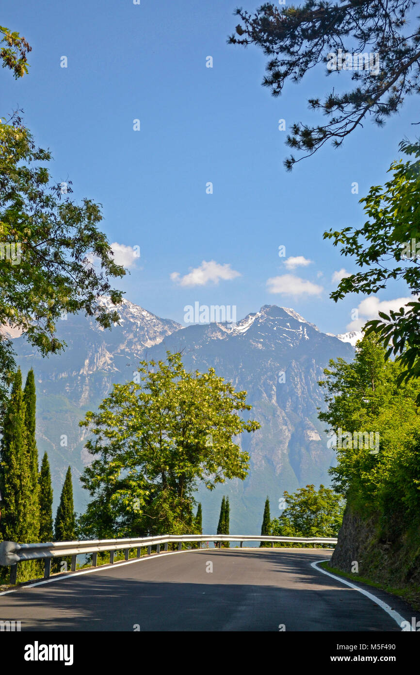 Winding road with mountains in Italy Stock Photo - Alamy
