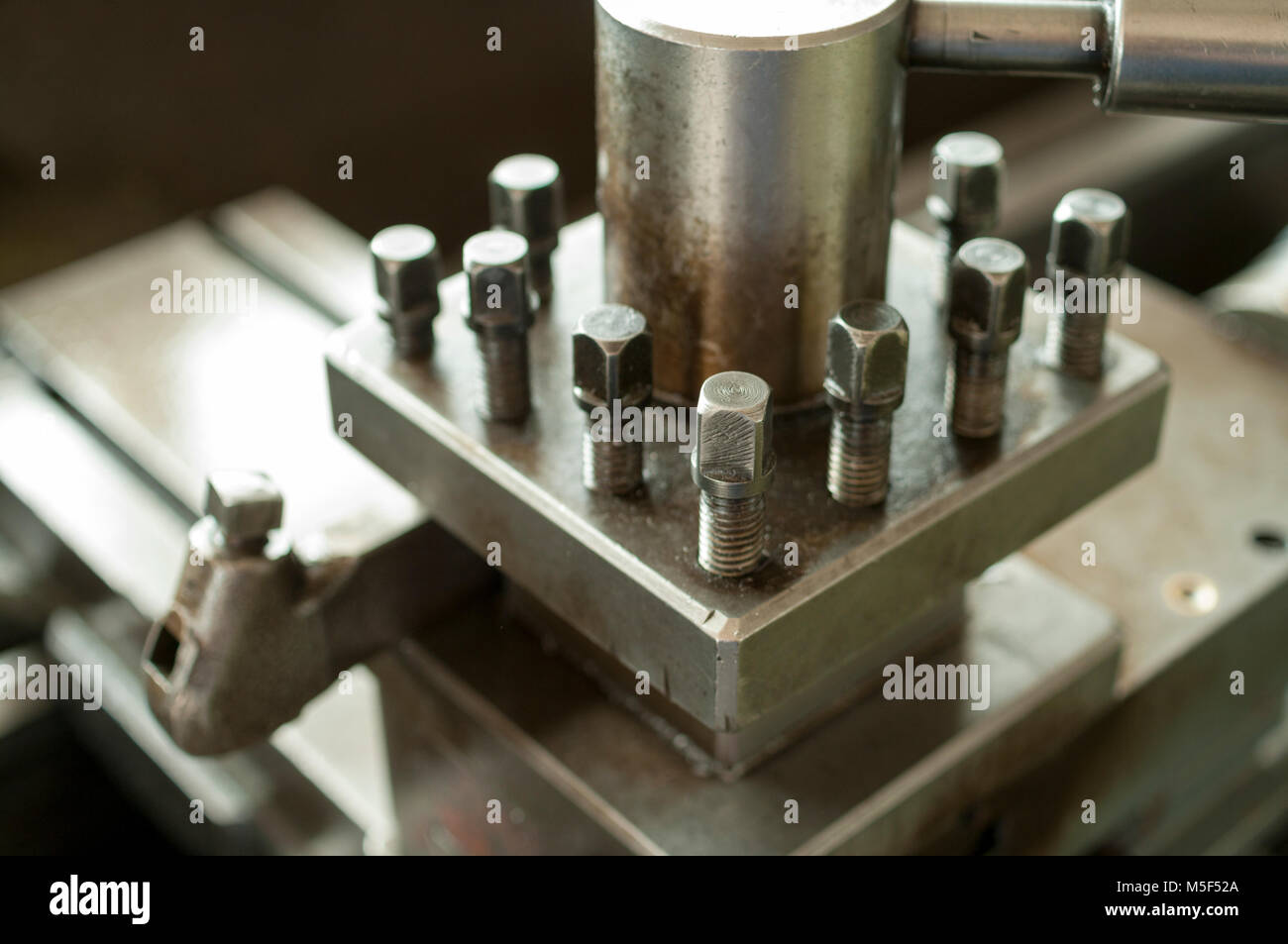 Closeup of lathe machine tool post on cross slide Stock Photo