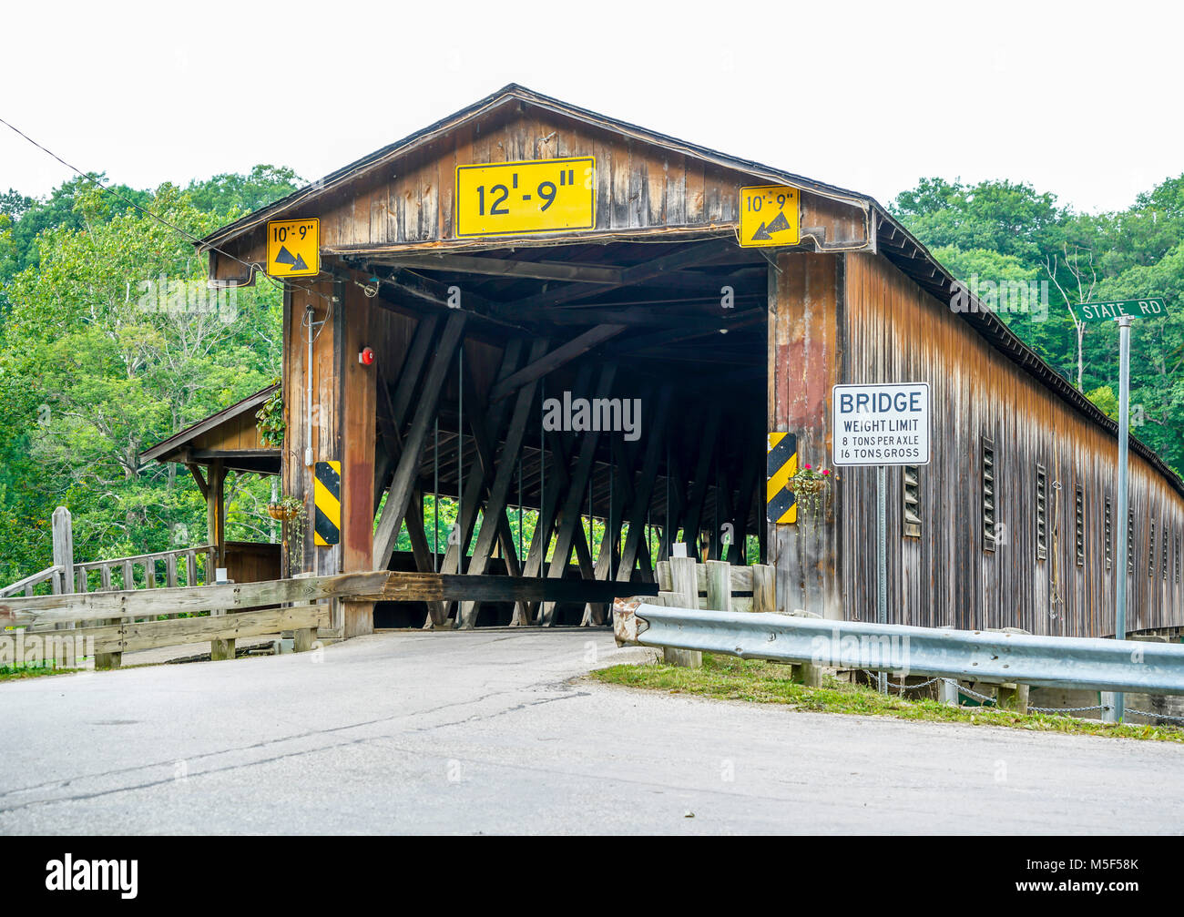 This is Harpersfield Covered Bridge that spans the Grand River in northeast Ohio the bridge is over a hundred years old and cars cross it every day. Stock Photo