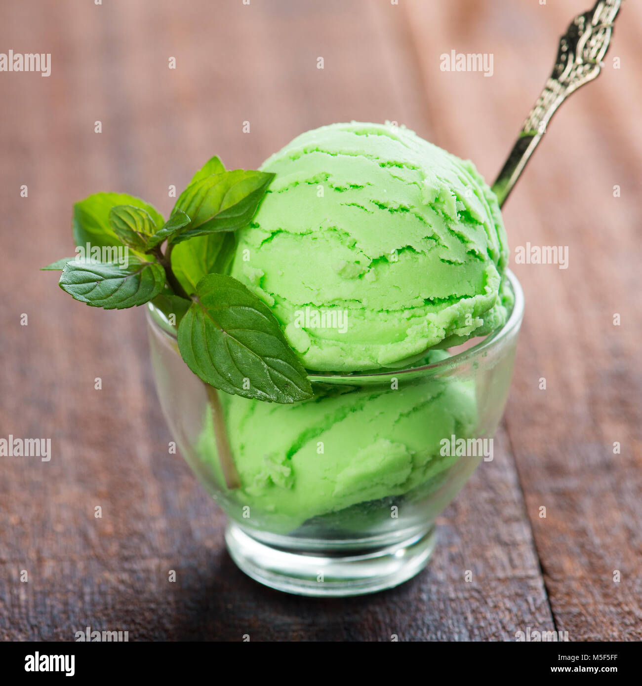 Honeydew ice cream in cup on dining table Stock Photo Alamy