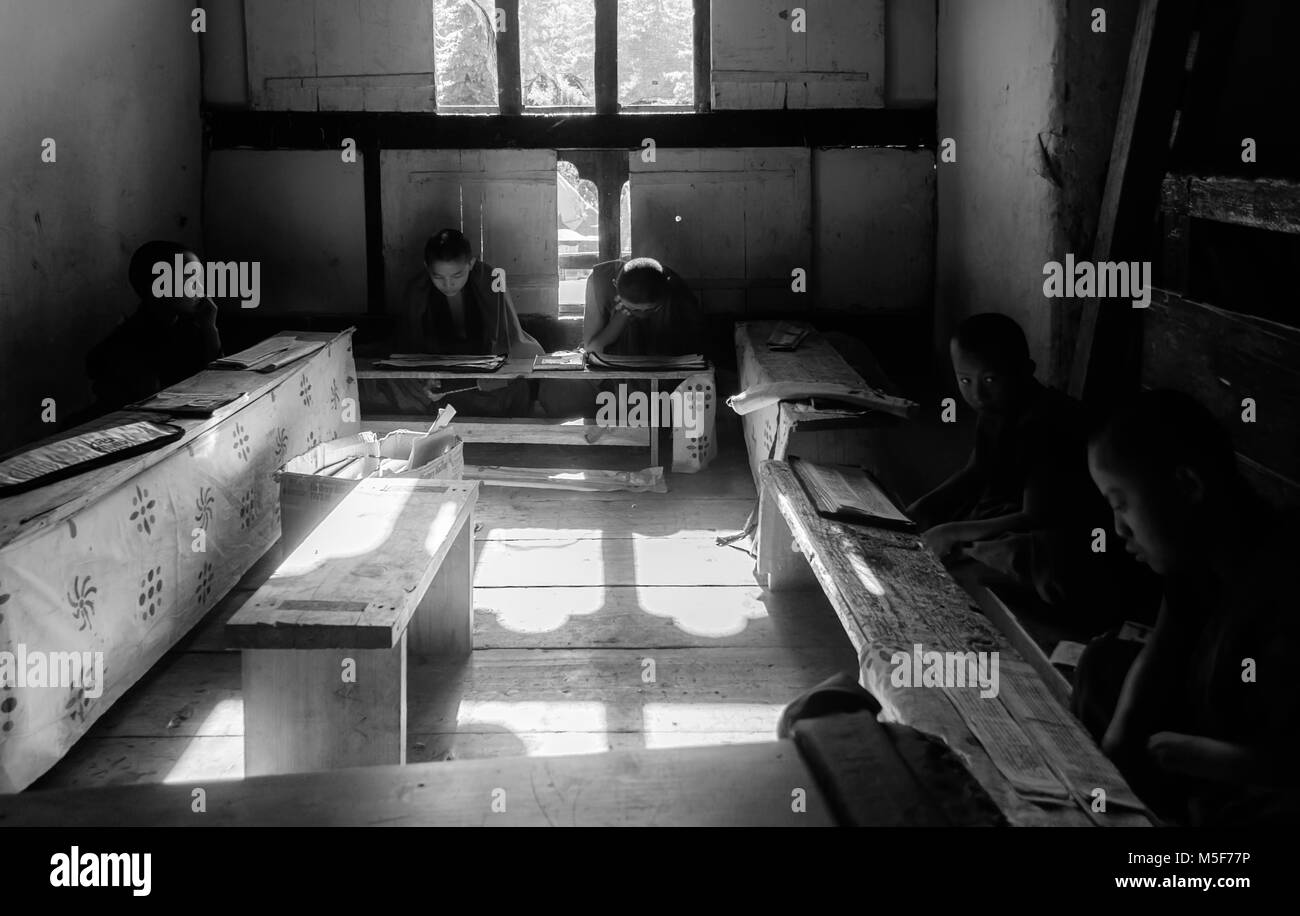 Bhutanese Students studying religious scriptures, Buddhism in a monastery in monochrome with copy space Stock Photo
