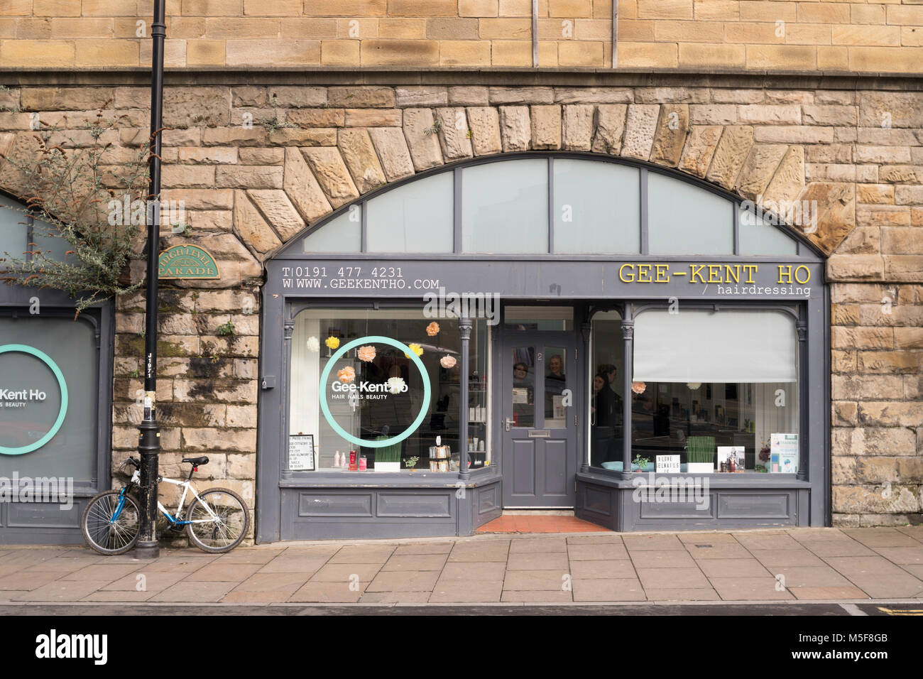 Gee-Kent Ho,Hairdresser's salon under a railway arch in Gateshead, north east England UK. Stock Photo