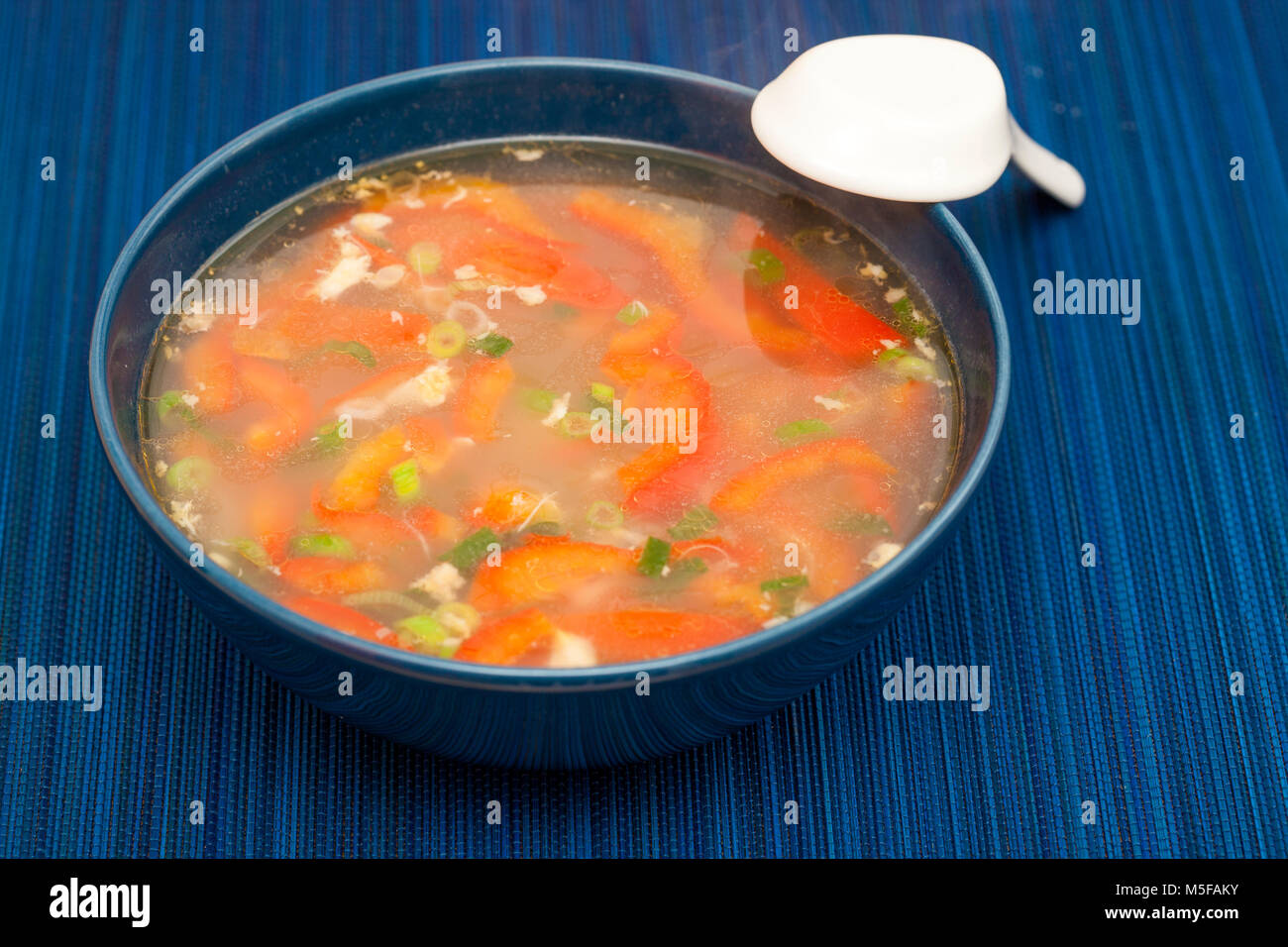 korean soba buckwheat noodle soup in a dark blue bowl Stock Photo Alamy
