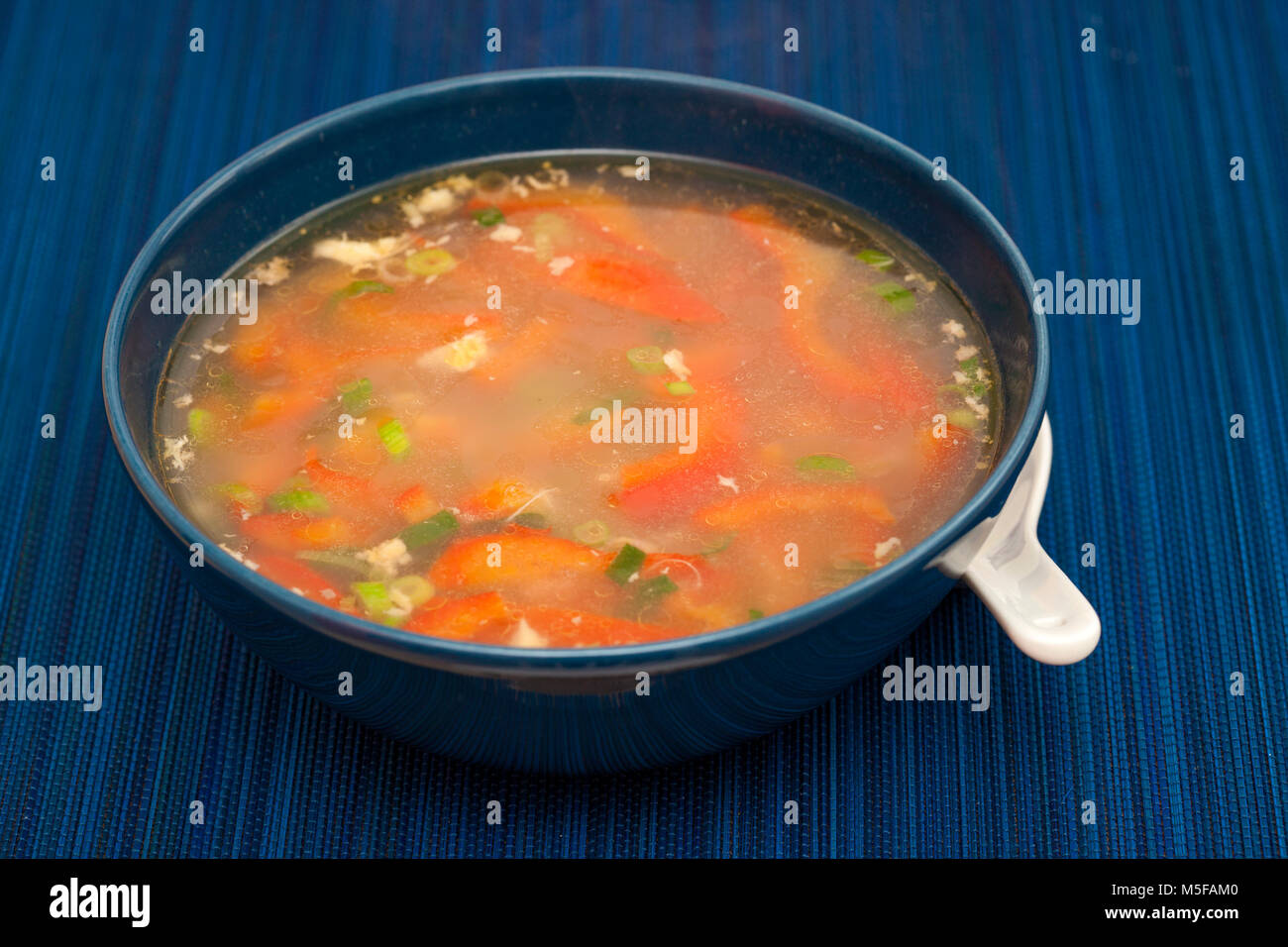 korean soba buckwheat noodle soup in a dark blue bowl Stock Photo Alamy