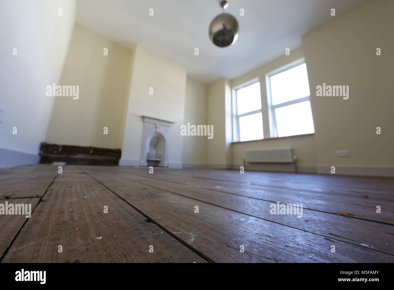 Old bare floorboards in an empty bedroom in a victorian terraced house. Stock Photo