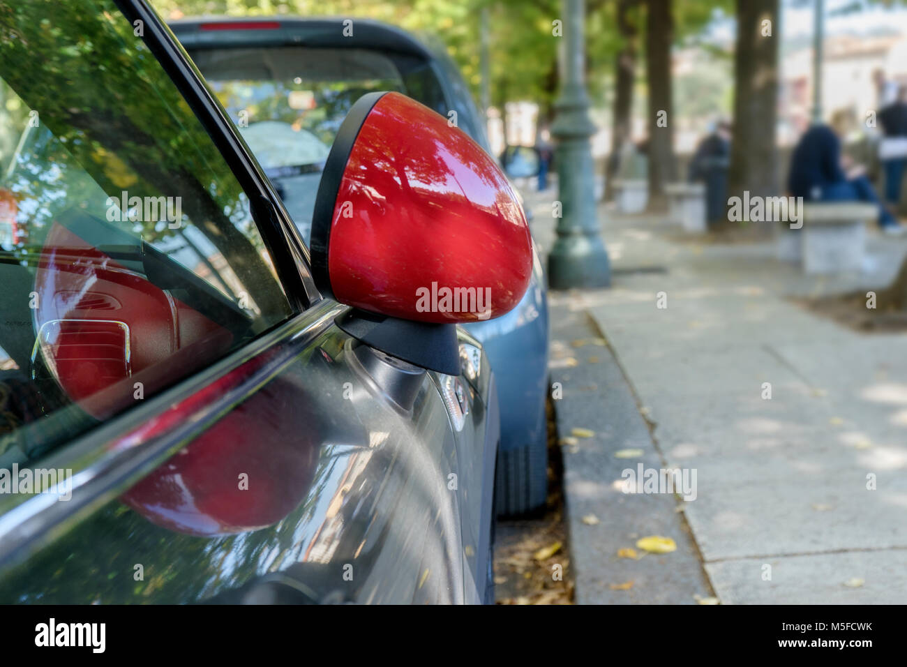 Detail of a car with red hinged exterior mirror Stock Photo