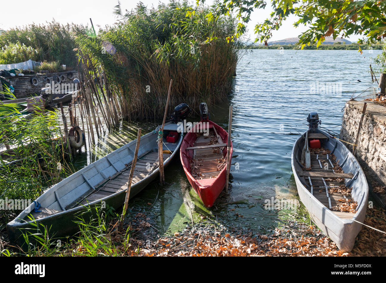 Traditional fishing boats on the Island of Nissi on Lake Pamvotidha, Ioannina, Epirus, northern Greece. Stock Photo