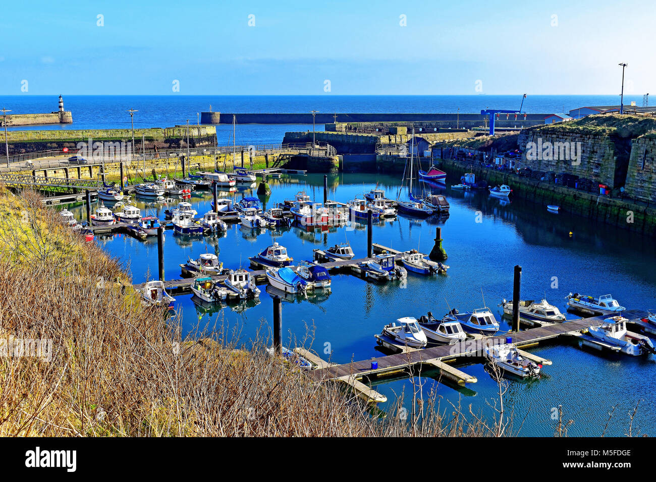 Seaham Durham harbour and lighthouse with marina boats and yachts Stock Photo